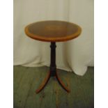 An Edwardian mahogany circular side table on three outswept legs