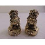 A pair of Chinese silvered Dogs of Foe on circular bases, marks to the bases