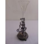 A single stem glass centre piece mounted in a silver plated scrollwork frame on three ball feet