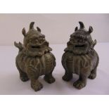 A pair of oriental bronze incense burners in the form of temple lions