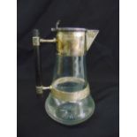 A silver mounted glass claret jug with cylindrical wooden handle and flat hinged cover, Sheffield
