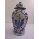 A Chinese blue and white vase and cover, with stylised images and flowers to the sides