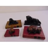 Four paperweights in the form of animals on faux leather mounted books