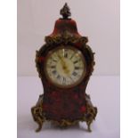 A Boule work mantle clock of customary form, with white enamel dial and Roman numerals