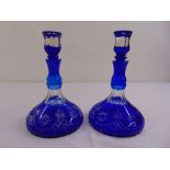 A pair of continental blue overlaid glass ships decanters with drop stoppers, one A/F (chip on rim)