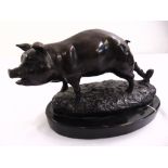 A cast bronze figurine of a tethered pig on naturalist base and black marble plinth