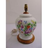 A Herend baluster form porcelain lamp base decorated with flowers and leaves on turned wooden base