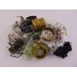 A quantity of costume jewellery to include bracelets, necklaces, earrings, bangles and brooches