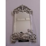 A silvered Art Nouveau style table mirror shaped rectangular with stylised vegetation and a