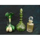 A Venetian green glass jug decorated with flowers and leaves, and two decanters with drop stoppers