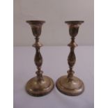 A pair of silver table candlesticks, baluster form on raised circular bases, London 1976