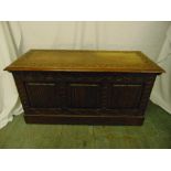 A 19th century rectangular oak chest with carved sides and hinged cover