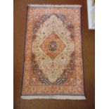 A Persian wool carpet, red and blue ground central medallion within organic and stylised geometric