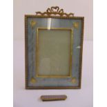 A gilt metal and fabric decorative photograph frame and a gilt metal and enamel hair clip