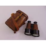 A pair of British WWI military binoculars in fitted leather case
