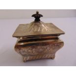 A Victorian silver tea caddy of casket form, chased with flowers and leaves with domed hinged cover,