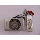 A Minox spy camera and a Cannon IXUS L1 camera