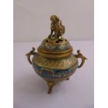 An oriental cloisonné incense burner of compressed cylindrical form with scroll handles and dog of