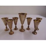 Seven silver Kiddush cups of varying size and form