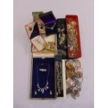 A quantity of costume jewellery to include brooches and necklaces