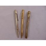 A silver fountain pen with 14ct gold nib, a silver propelling pencil and a gold plated propelling