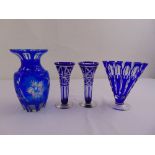 Four blue overlaid glass vases of various form and size