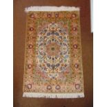 A Persian silk and wool carpet, brown green and blue with stylised natural and geometric forms
