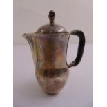 A Danish hand hammered silver coffee pot of baluster form, the domed pull off cover with bud finial,