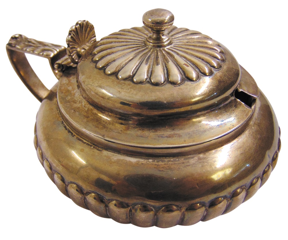 A George III silver mustard pot with hinged cover, shell thumb-piece and circular reeded body,