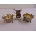 A Victorian silver cream jug London 1899 and two bowls London 1899 and Birmingham 1918 on hoof feet