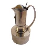 A silver olive oil dispenser of cylindrical form with scroll handle on cylindrical base, the