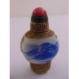 Peking glass snuff bottle, blue and white landscape to the sides with cabochon stopper