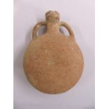 A Roman terracotta water flask of compressed spherical form with two side handles