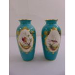 A pair of early 20th century Minton baluster form vases decorated with stylised exotic birds,