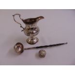 A George III silver cream jug baluster form, the sides chased with windmills, punch bead border,