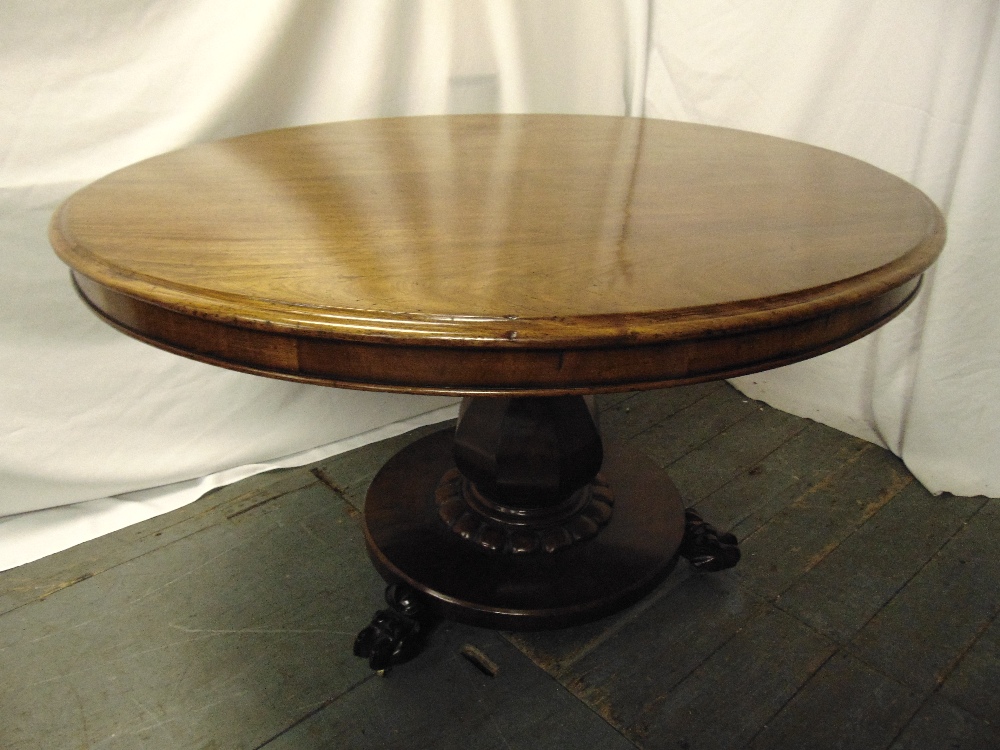 A Victorian mahogany circular tilt top dining table on circular base with claw feet