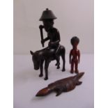 A quantity of Senufo Ivory Coast tribal carved wooden figurines to include a man wearing a hat on