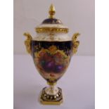 A Coalport vase and cover with gilded rams mask side handles the sides painted with fruits, the