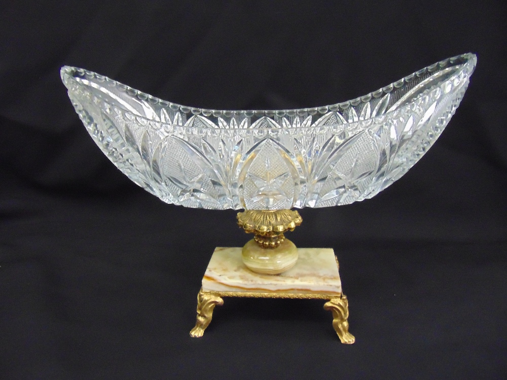 A cut glass oval fruit bowl on raised gilded metal and marble base