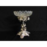 A Victorian silver table centre piece of vine and grape form on raised lobed base supported by three