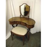 An Edwardian kidney shaped mahogany dressing table and stool with shield shaped mirror