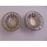 A pair of oval scroll pierced silver bonbon dishes on raised oval bases, Sheffield 1906