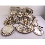 A quantity of silver plate to include trays, platters, tea sets and an ice bucket
