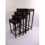 A 20th century quartetto of Chinese hardwood nesting tables, each of rectangular form with foliate