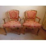 A pair of French upholstered bedroom armchairs on cabriole legs