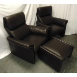 A pair of leather armchairs and a matching foot stool