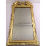 A George I gilded gesso mirror with rectangular bevelled plate, the frame carved and moulded with