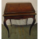 A 19th century rectangular walnut and mahogany desk with brass mounts on four cabriole legs