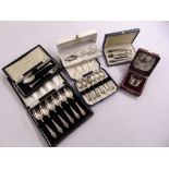 A quantity of silver and white metal cased spoons, a cased manicure set and a cased napkin ring