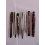 A quantity of pens and pencils to include fountain pens, ball point pens and a propelling pencil (
